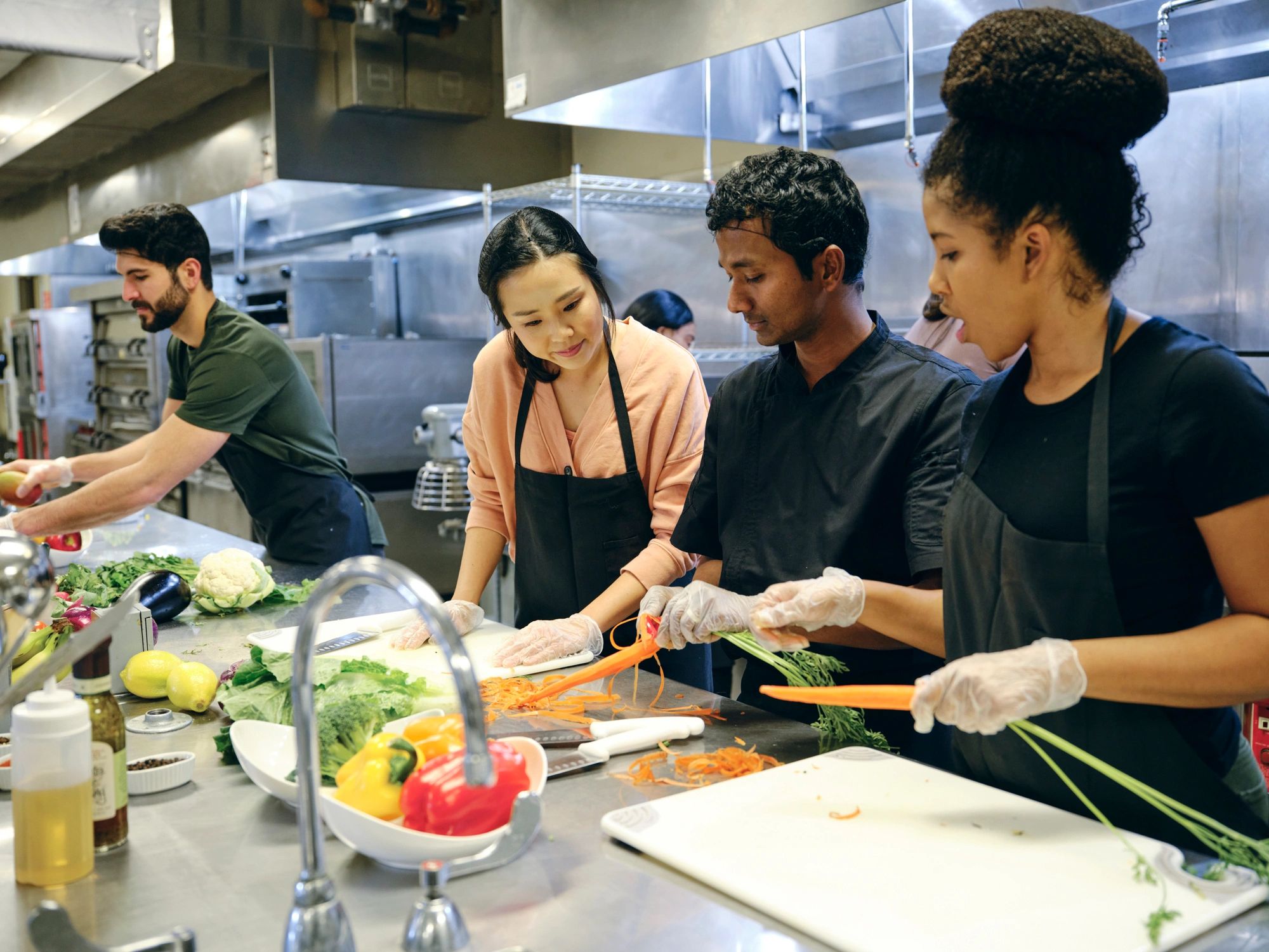Group of culinary students learning in a training kitchen
