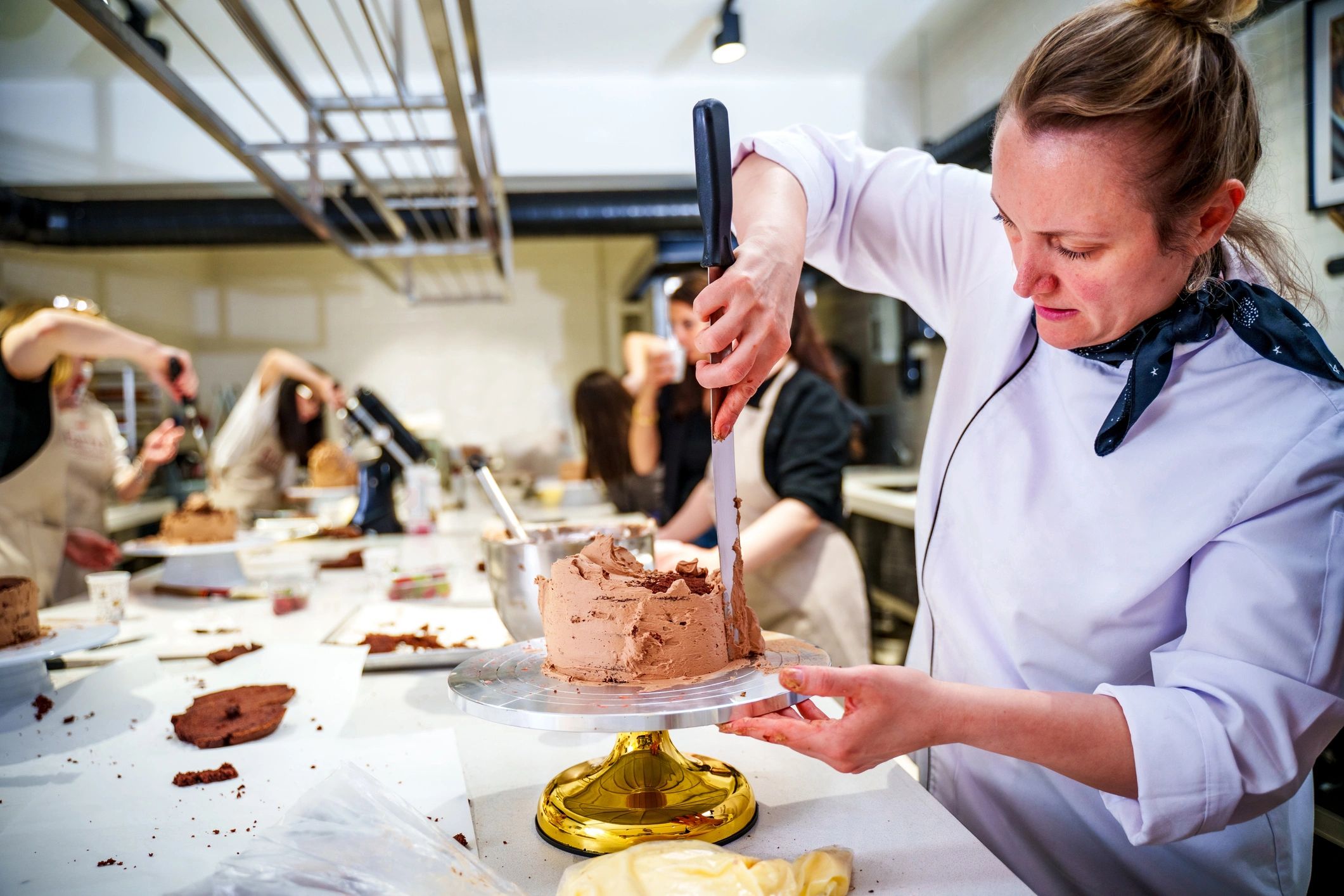 Cake decorating demonstration in a professional training class