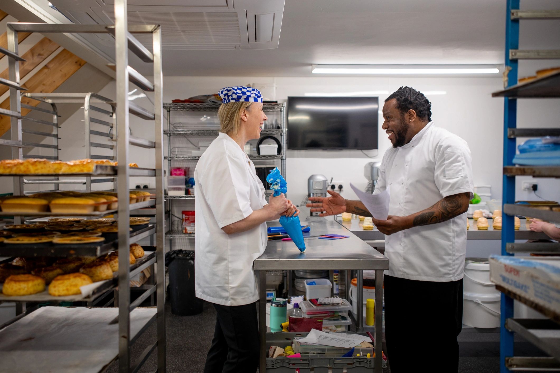 Pastry chefs discussing cake decorating techniques